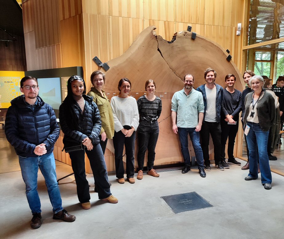 Workshop participants in front of tree-ring disc