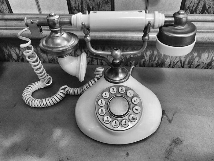 A black and white photograph of an old telephone