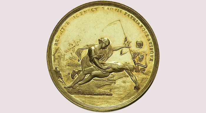 An old medal showing the saving of drowning people.