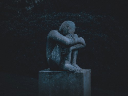 sculpture of depressed person