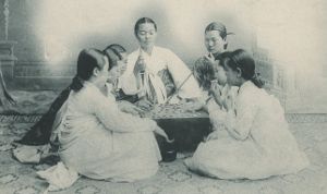 Seven women sitting in a circle on the floor.