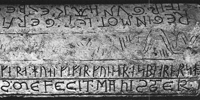 Runes and latin letters carved on a stone.