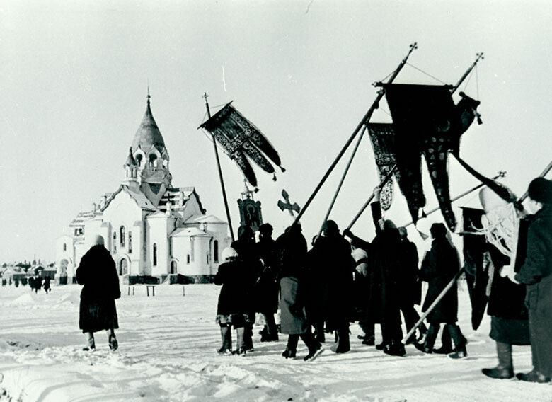 Black and white photo of procession in front of a church.