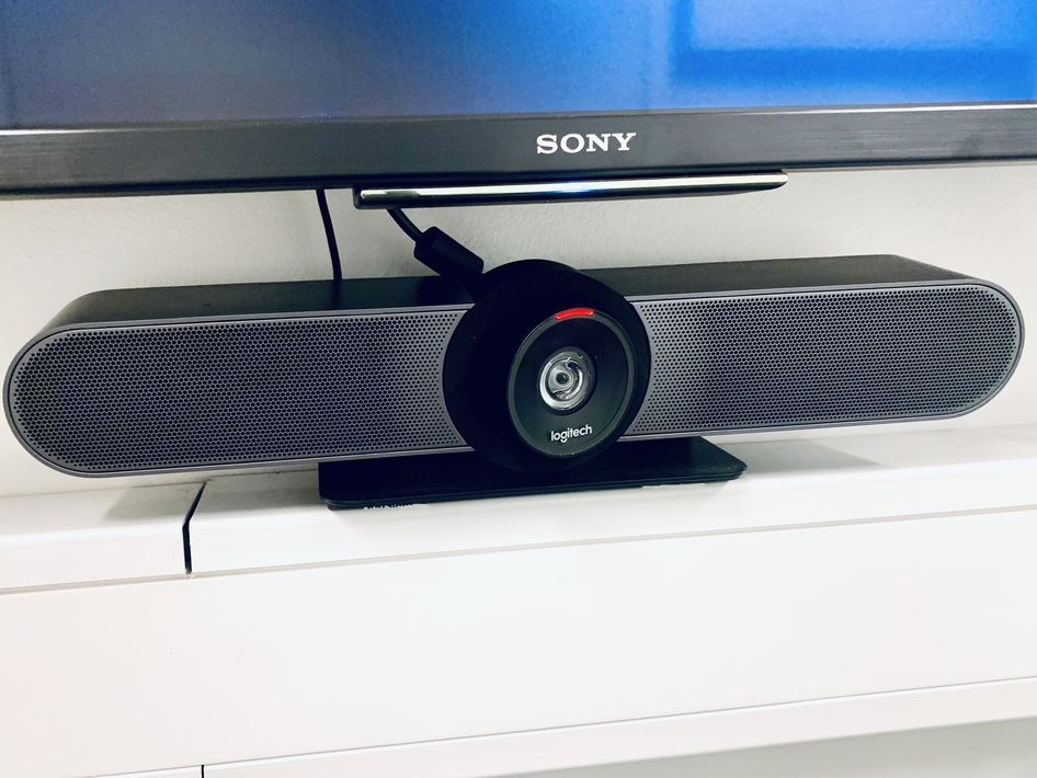 Video conference system with camera and speakers in group room